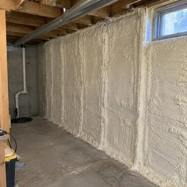 Closed cell spray foam covering a concrete basement foundation wall