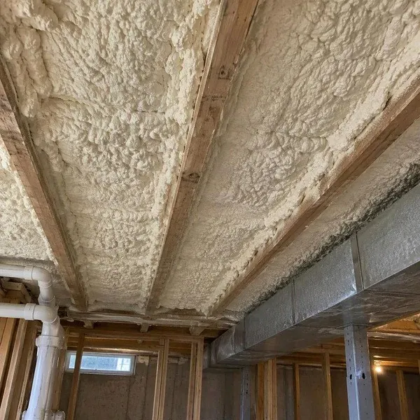 Close view of textured thermal acoustic spray insulation on a ceiling